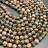 Blue quartz and pink feldspar in brown round beads.