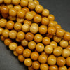 Round yellow beads for jewelry making. Australian Yellow Mookaite loose beads.