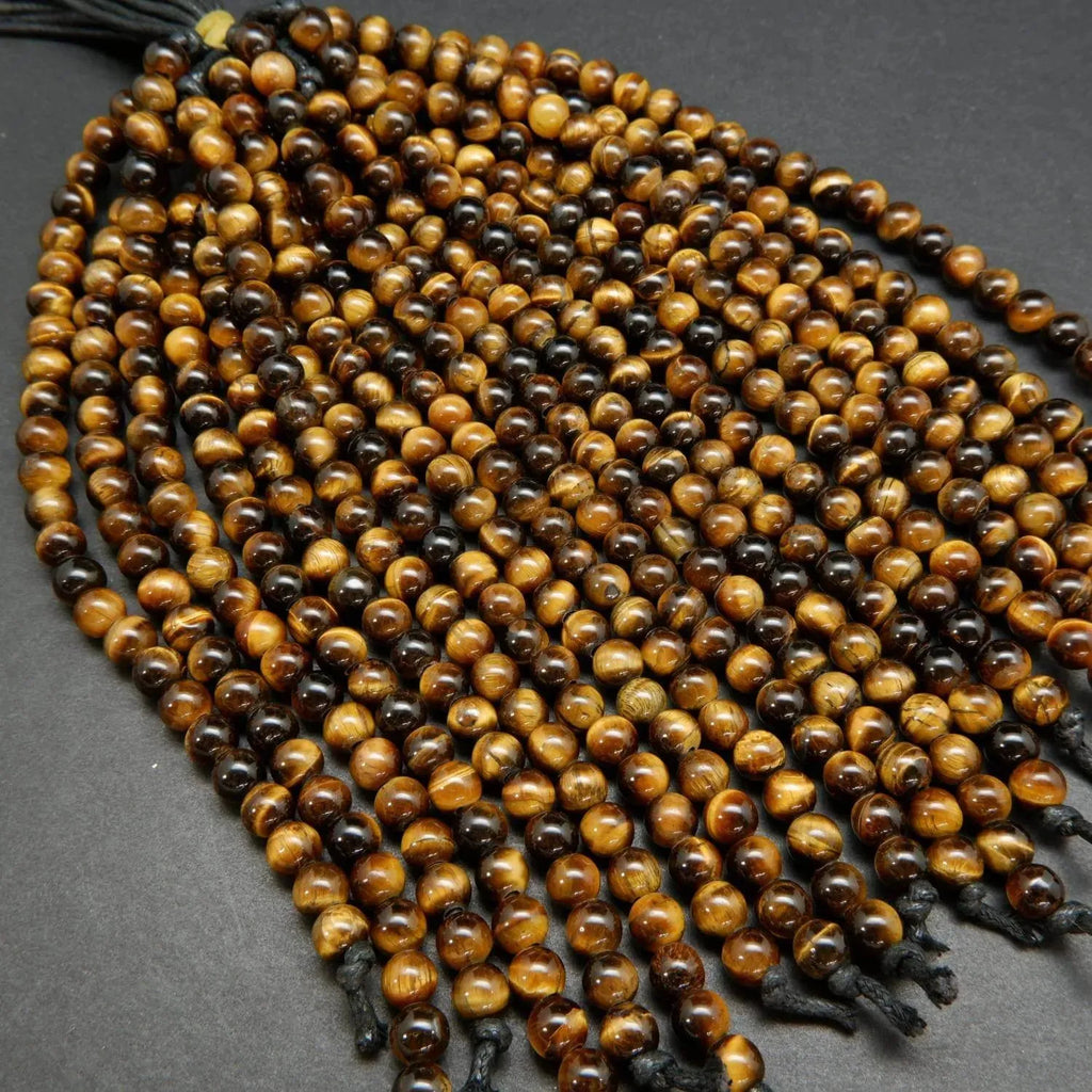 Yellow and brown tones in these polished round tiger's eye beads.