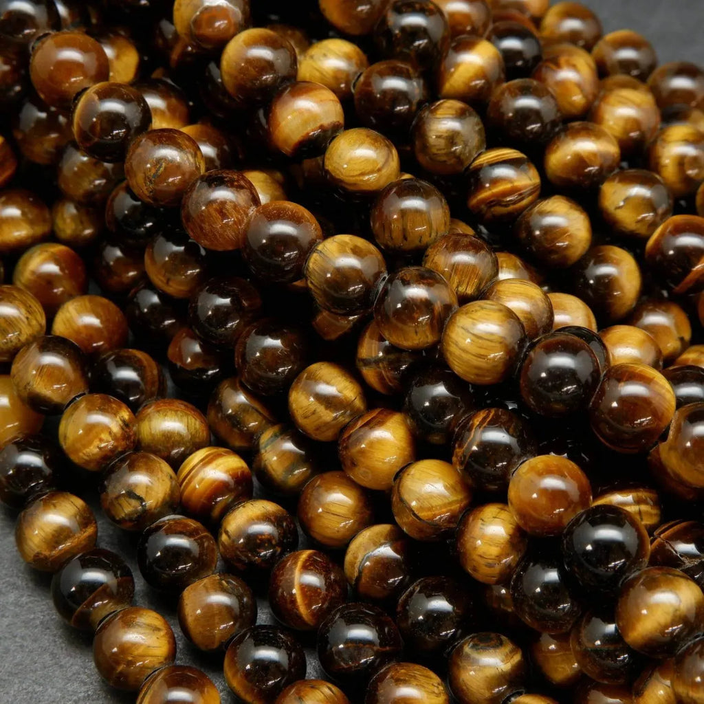 Yellow and brown tones in these polished round tiger's eye beads.