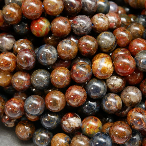 Brown, blue, and red round polished pietersite beads.