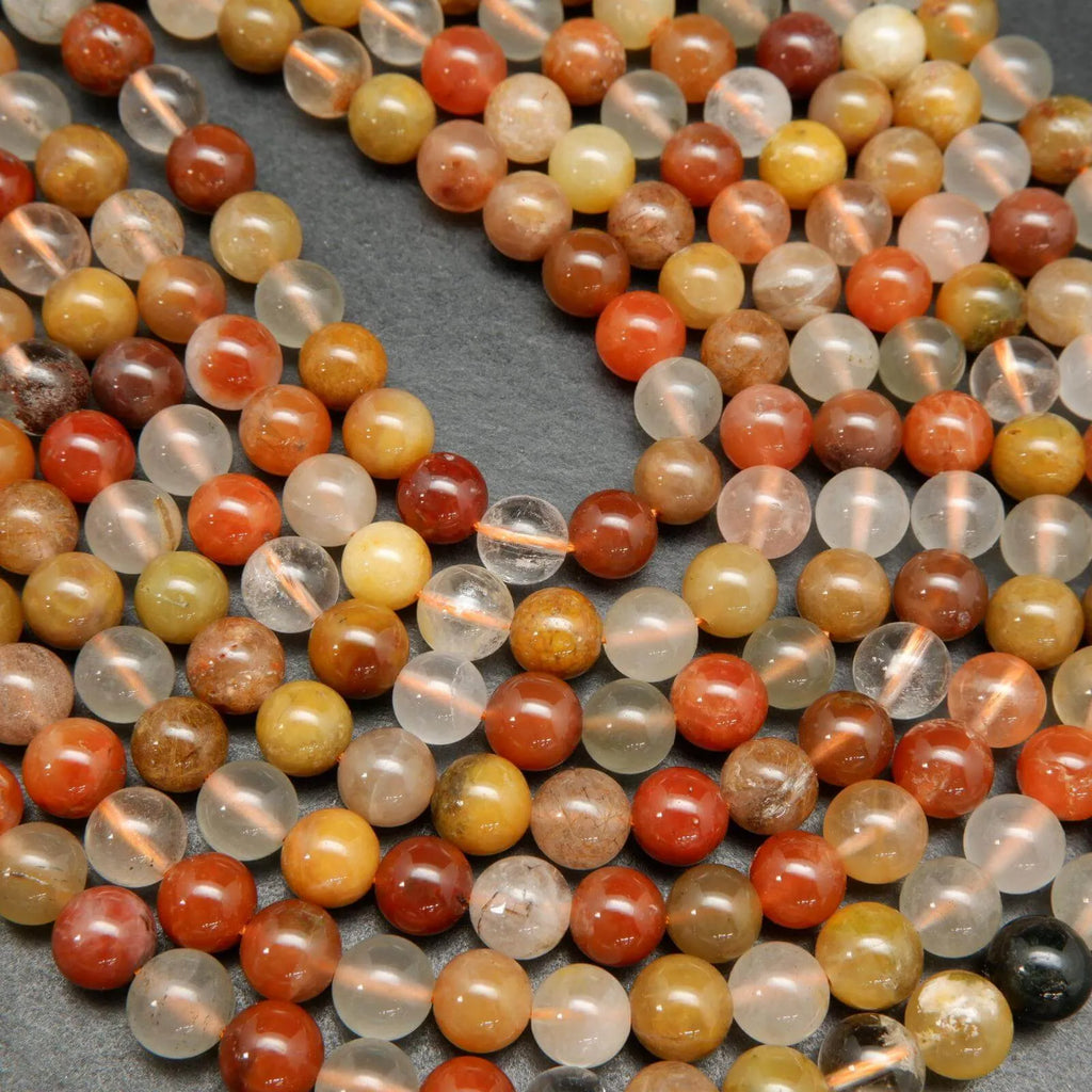 Mixed red and golden yellow rutilated phantom quartz beads.